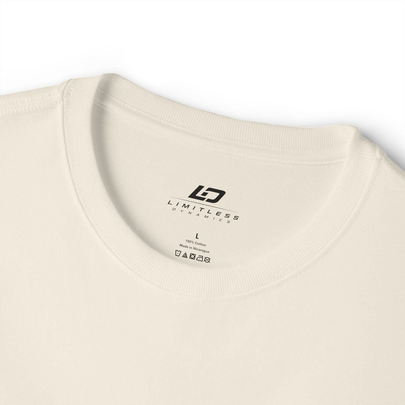 Cream tee collar detail with Limitless Dynamics label
